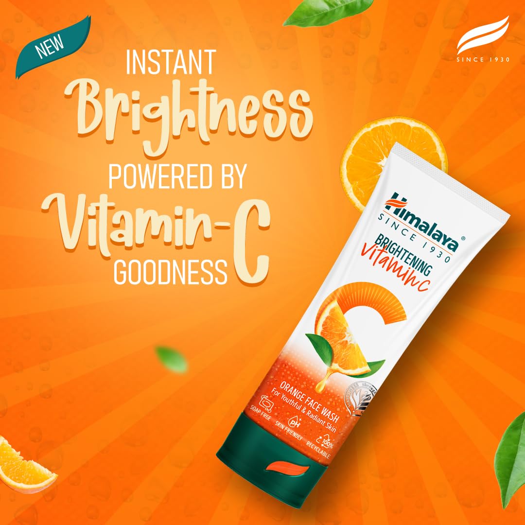 Himalaya Brightening Vitamin C face wash tube on an orange background with text about instant brightness.