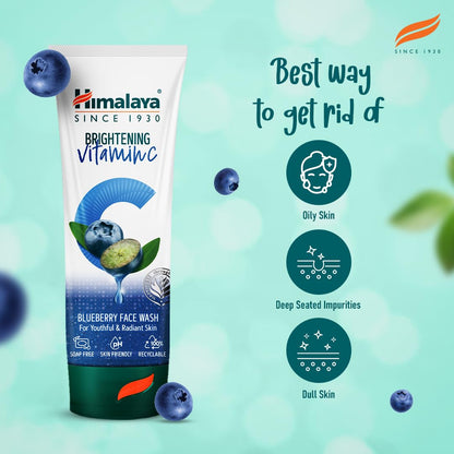 Himalaya Brightening Vitamin C Blueberry Face Wash tube with blueberries on a light green background
