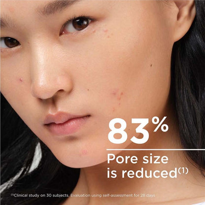 Close-up of a person's face with text indicating 83% pore size reduction.
