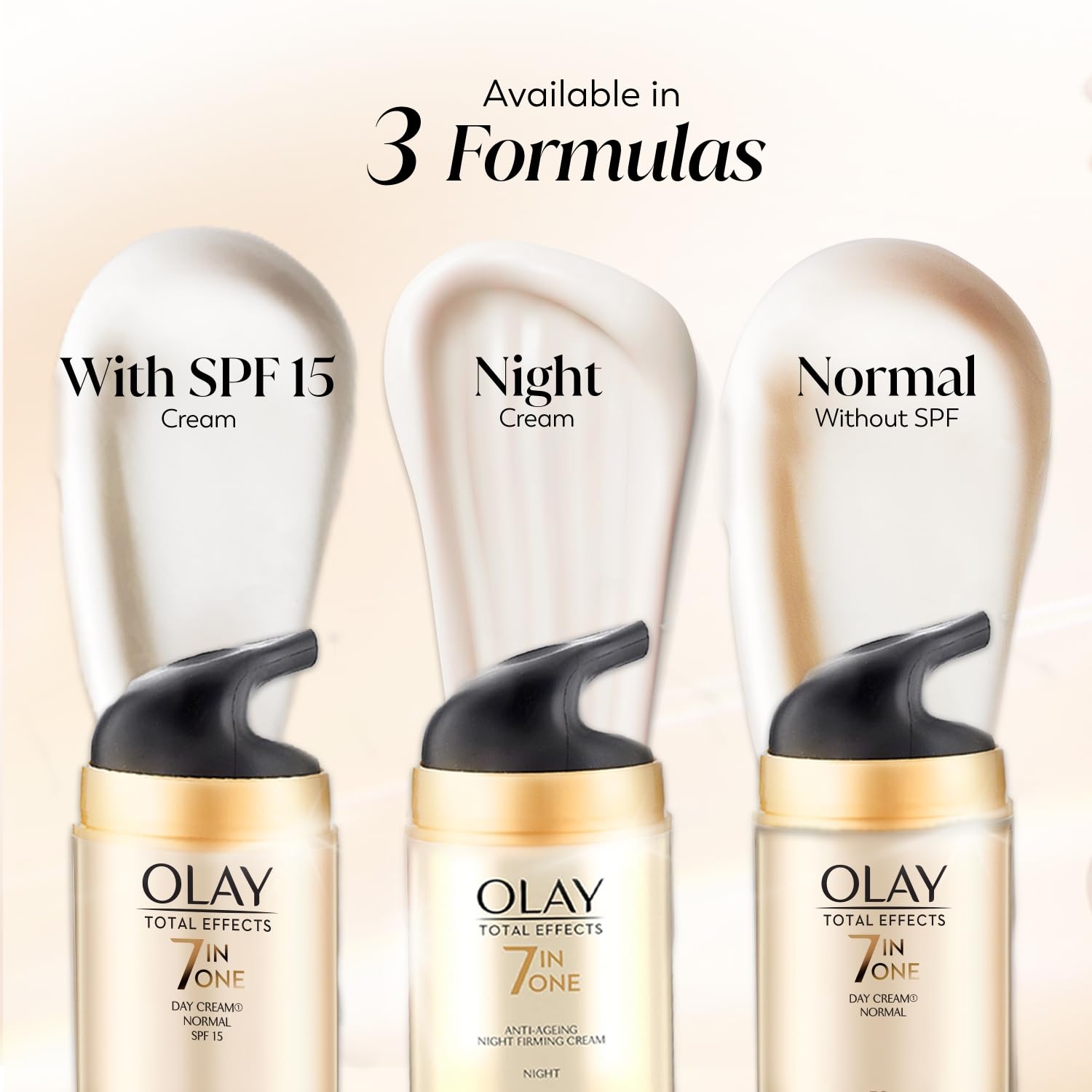 Three Olay Total Effects skincare products with labels for SPF 15, Night, and Normal on a beige background.