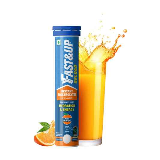 Fast&Up Reload instant electrolytes with a glass of orange juice on a white background