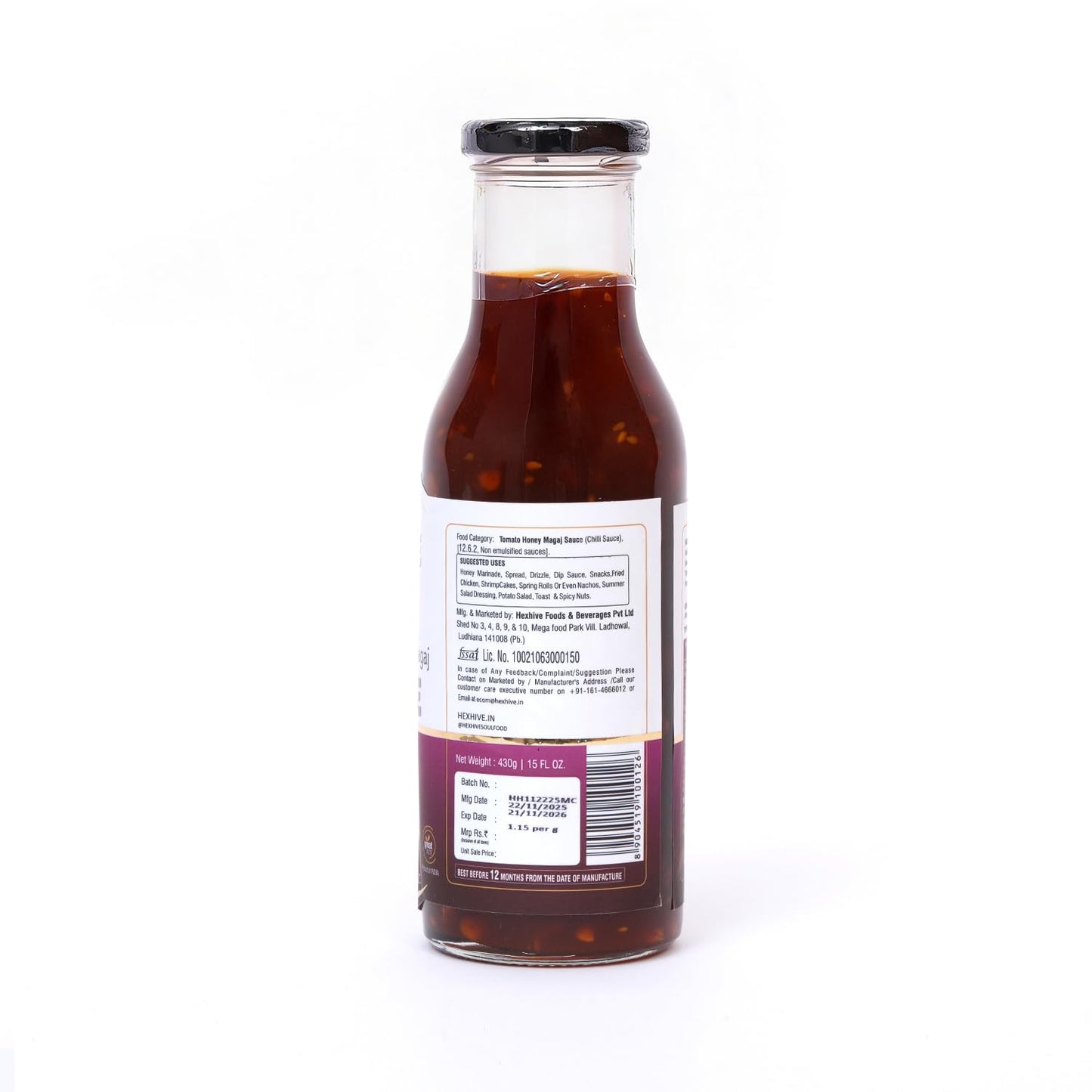 Bottle of sauce with a label on a white background