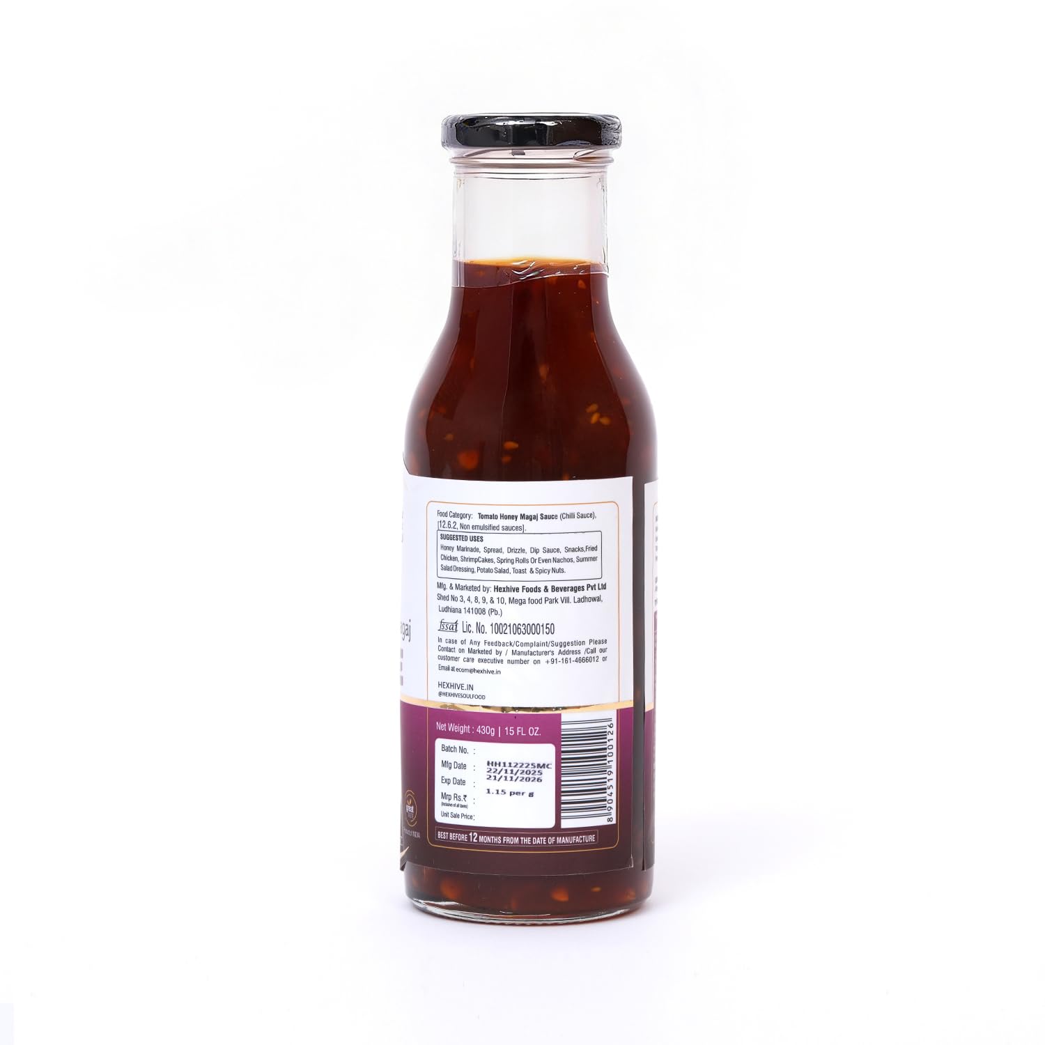 Bottle of sauce with a label on a white background