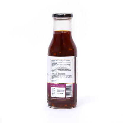 Bottle of sauce with a label on a white background