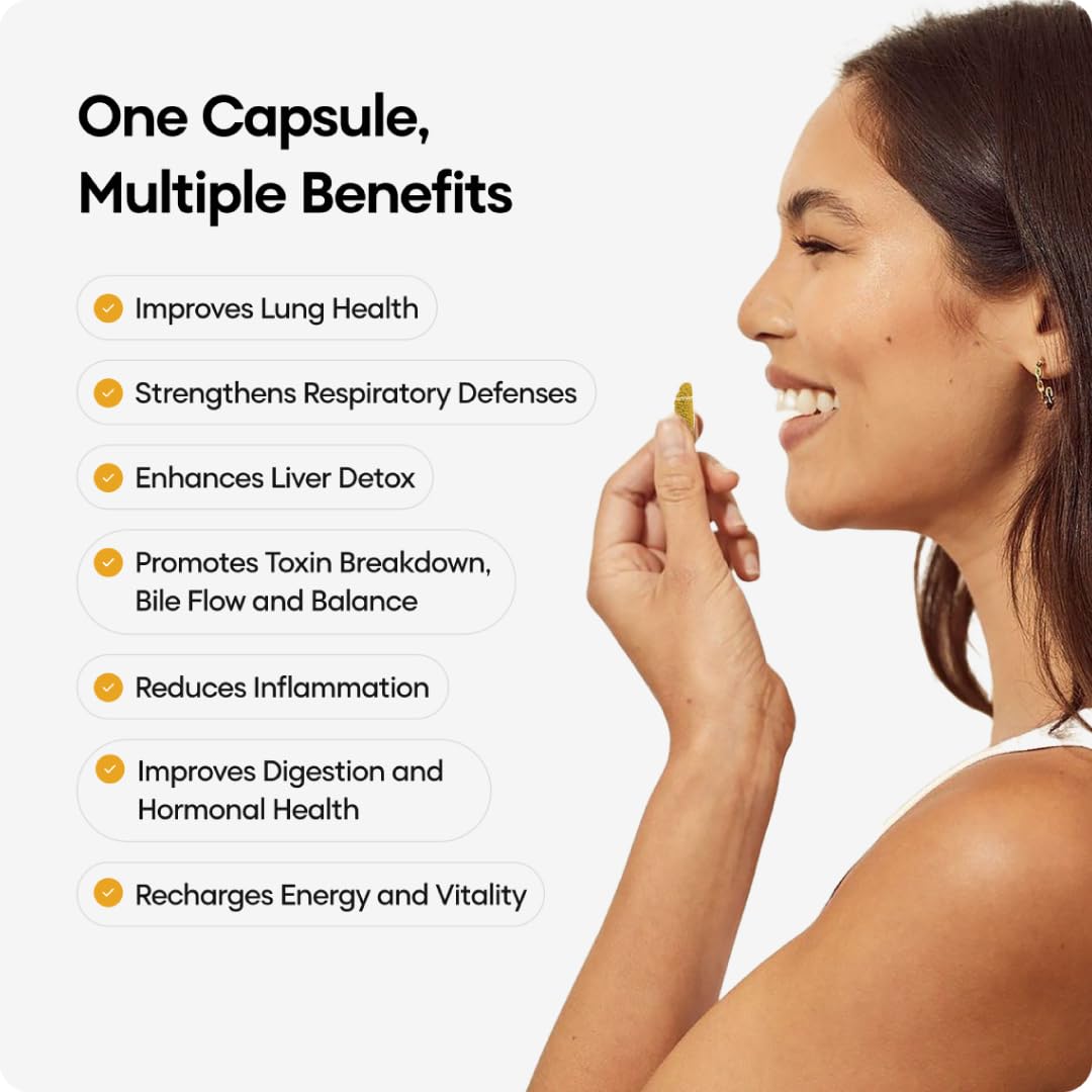 Woman holding a capsule with health benefits listed on a white background