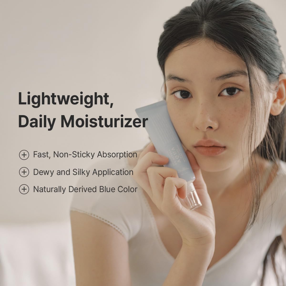 Woman holding a skincare product with text about a lightweight daily moisturizer.