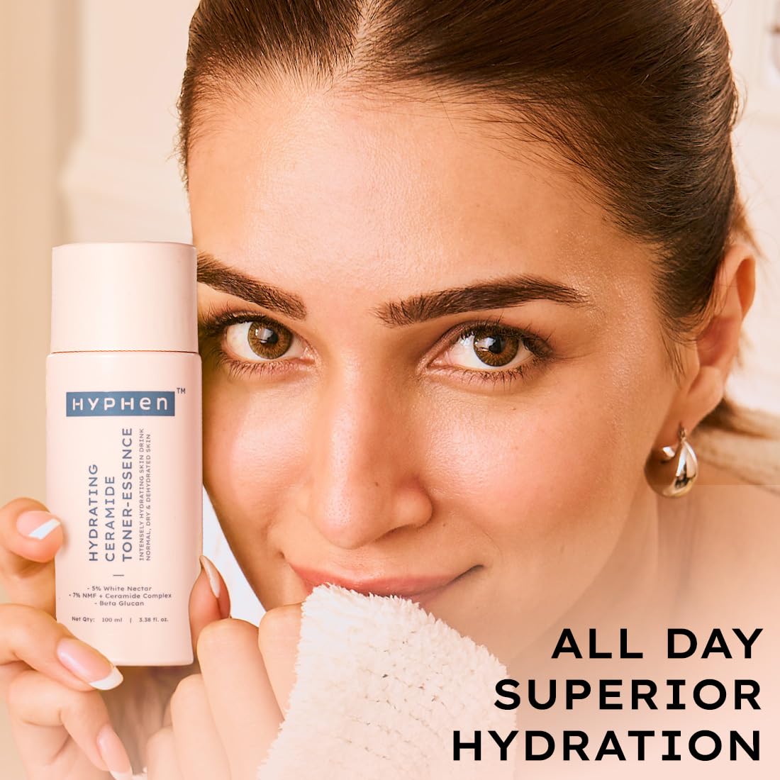 Woman holding a bottle of Hyphen skincare product with text 'All Day Superior Hydration'.