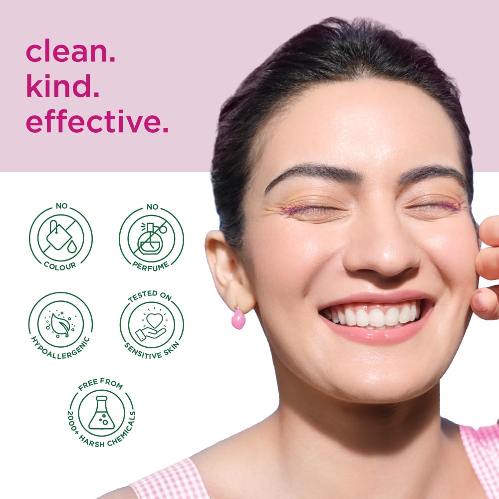 Woman with a happy expression, smiling, against a pink background with text 'clean. kind.