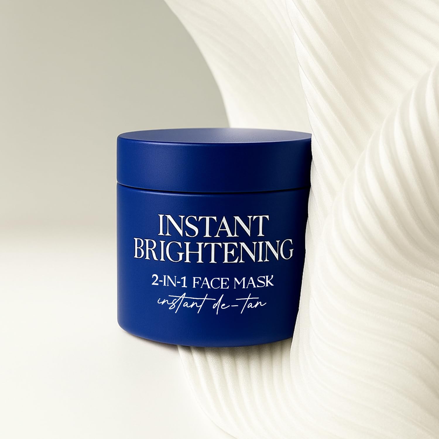 Blue jar of instant brightening 2-in-1 face mask on a textured white background