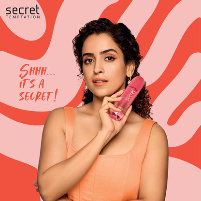 Woman holding a pink product with 'Secret Temptation' branding on a pink background