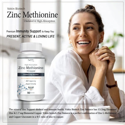 Woman smiling with a bottle of Vokin Biotech Zinc Methionine supplement in front of her.
