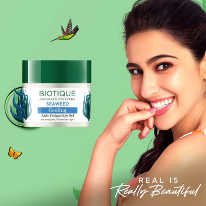 Biotique Seaweed eye gel with a woman smiling on a green background