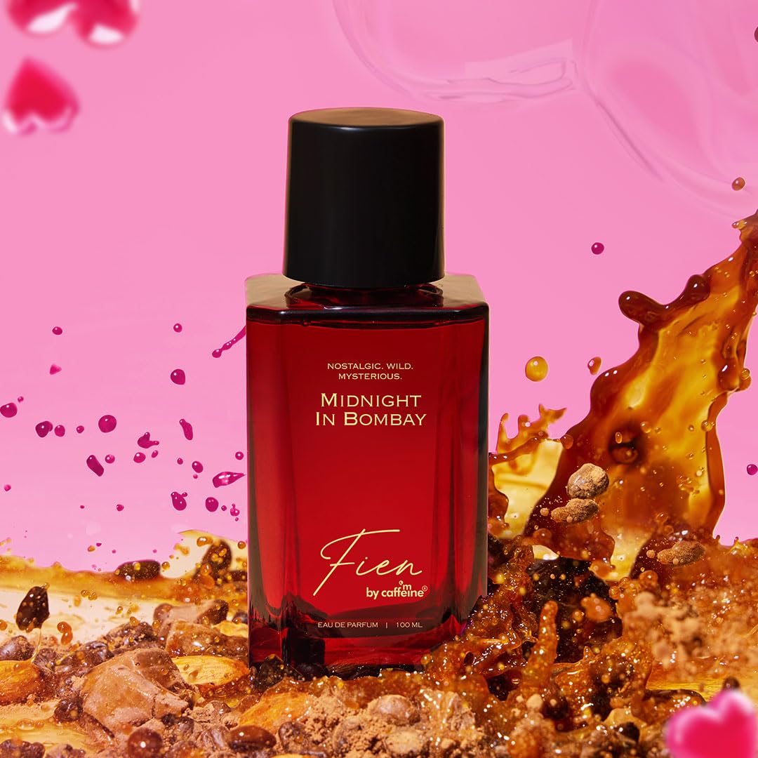 Red perfume bottle labeled 'Midnight in Bombay' by Fien on a pink background with gold liquid and heart shapes.