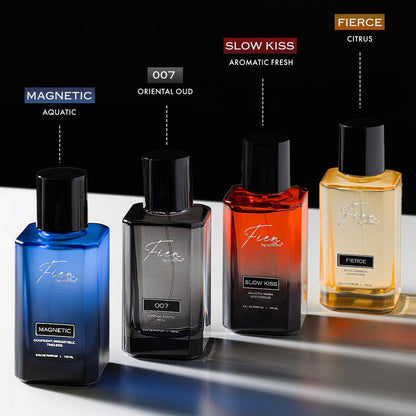 Four perfume bottles with labels indicating different scents on a reflective surface.
