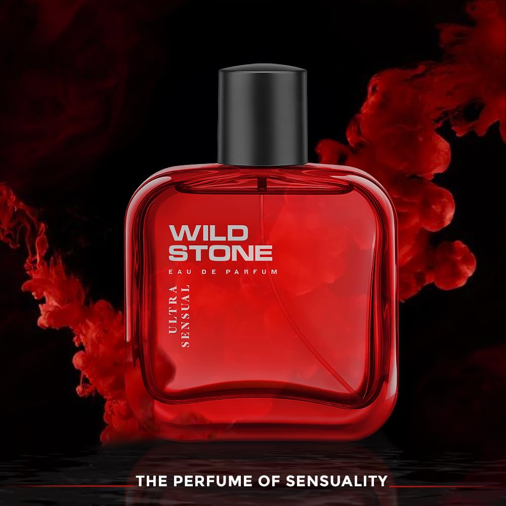 Red Wild Stone perfume bottle with black cap on a dark background with red smoke effects.