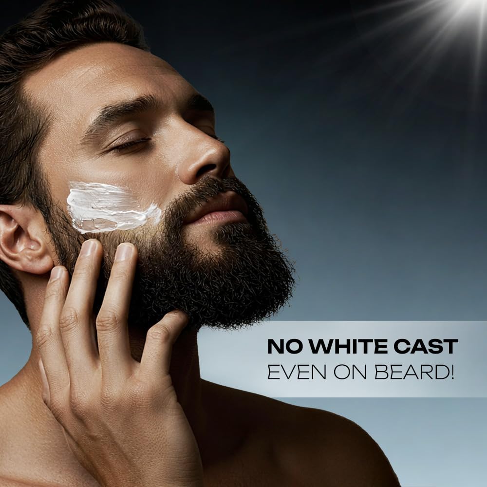 Man applying cream to his beard with a clear sky background