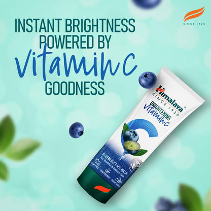 Himalaya Brightening Vitamin C face wash tube with blueberries on a light green background
