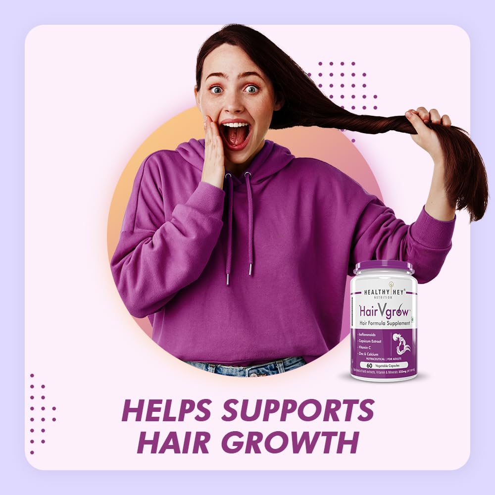 Woman in purple hoodie holding hair with a jar of HairVigor supplement on a light purple background