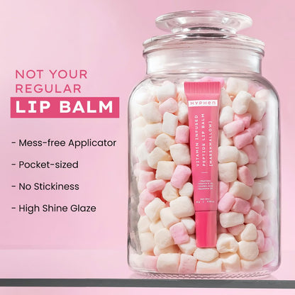 Pink lip balm in a jar filled with candy on a pink background