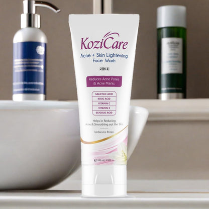KoziCare Acne + Skin Lightening Face Wash tube on a bathroom counter with other skincare products.