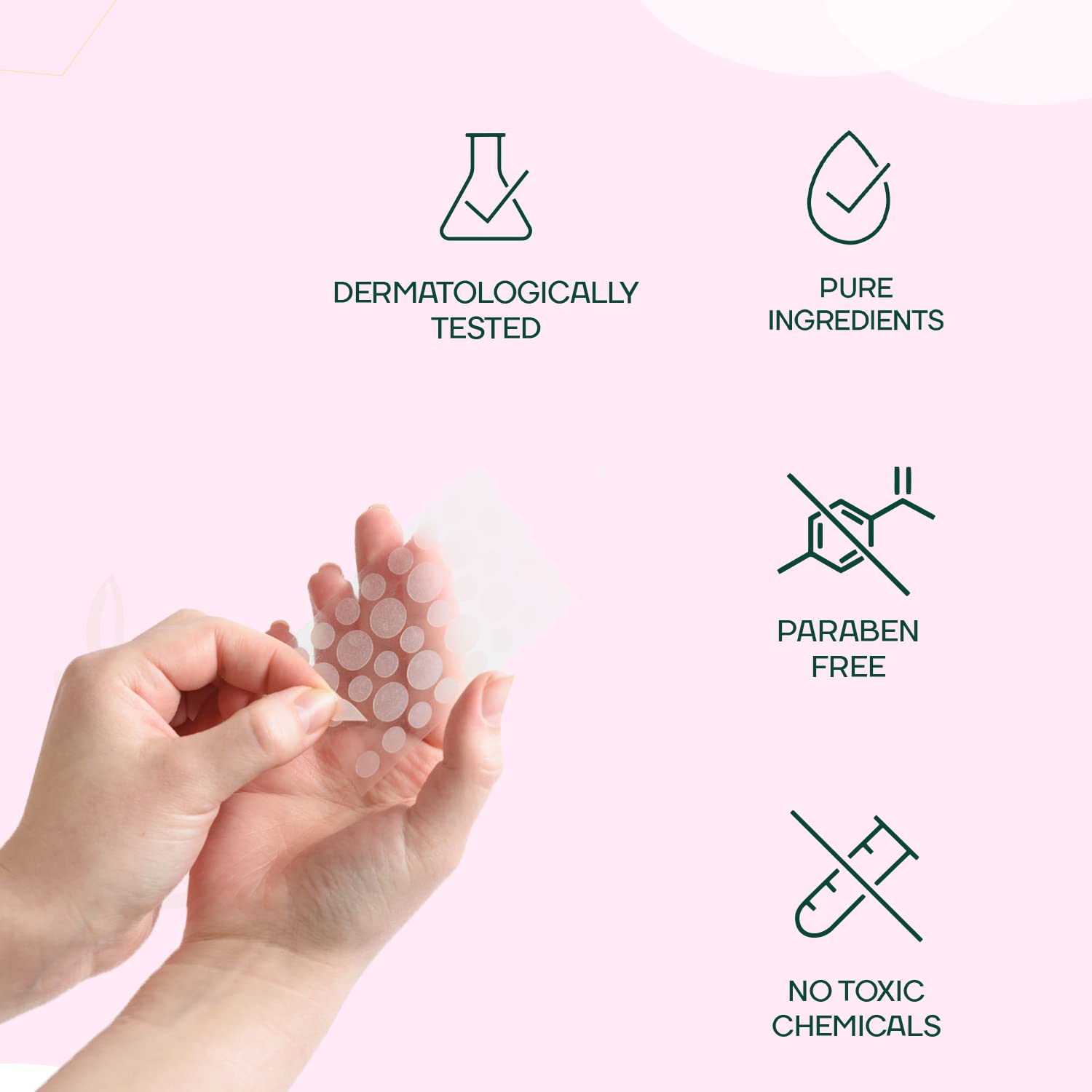 Hand holding a sheet of dots with icons and text indicating product features on a pink background