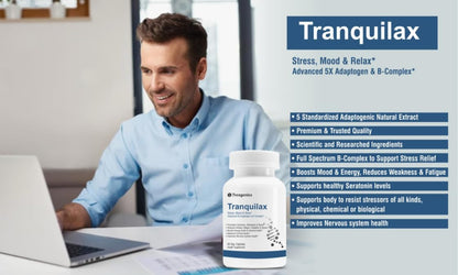 Man sitting at a desk with a laptop, smiling, next to a bottle of Tranquilax supplement.