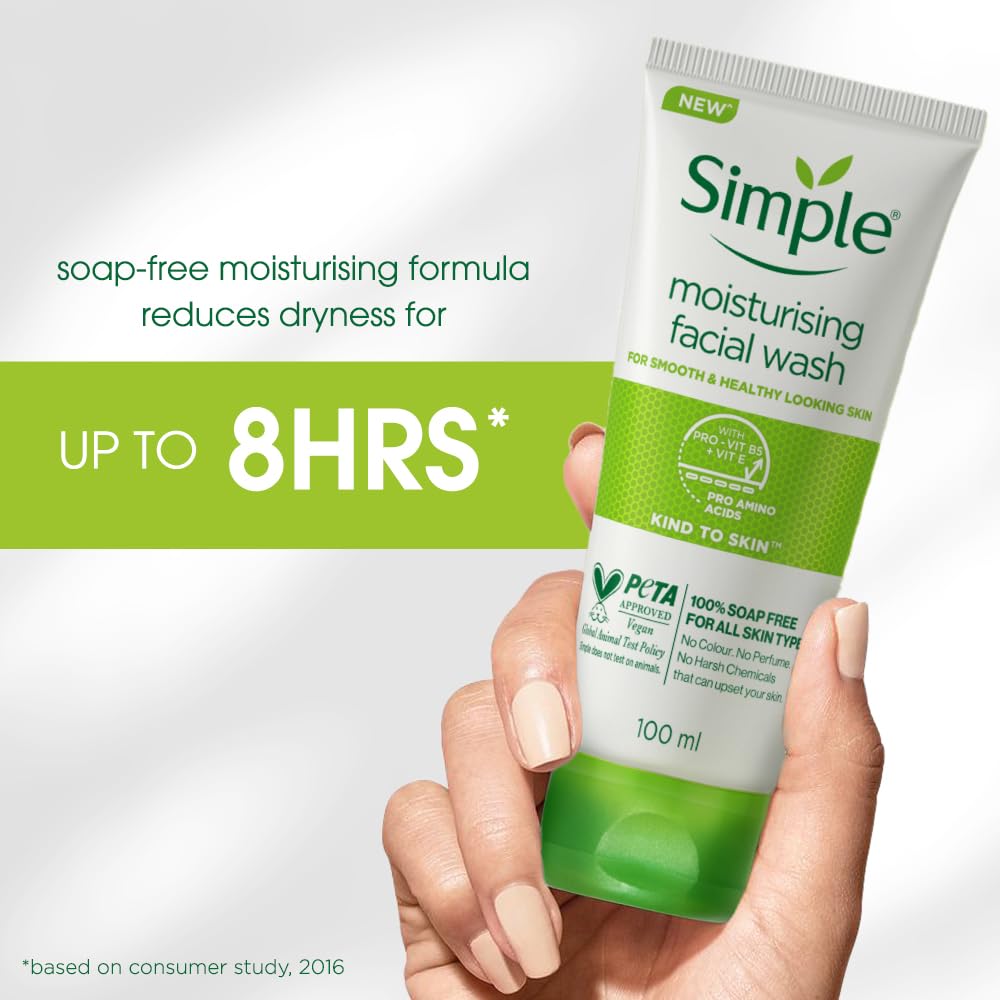 Hand holding a tube of Simple moisturising facial wash with product details on a light gray background