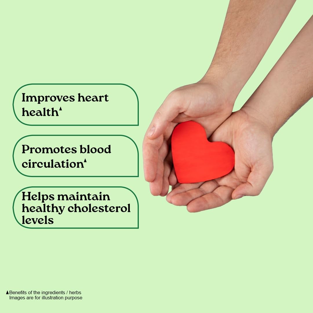 Hands holding a red heart with health benefits listed on a light green background