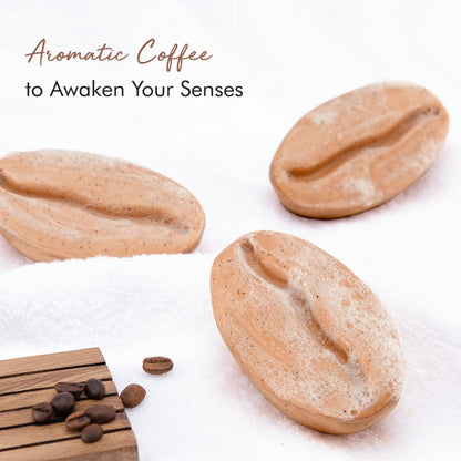 Three coffee beans on a white surface with text 'Aromatic Coffee to Awaken Your Senses'.