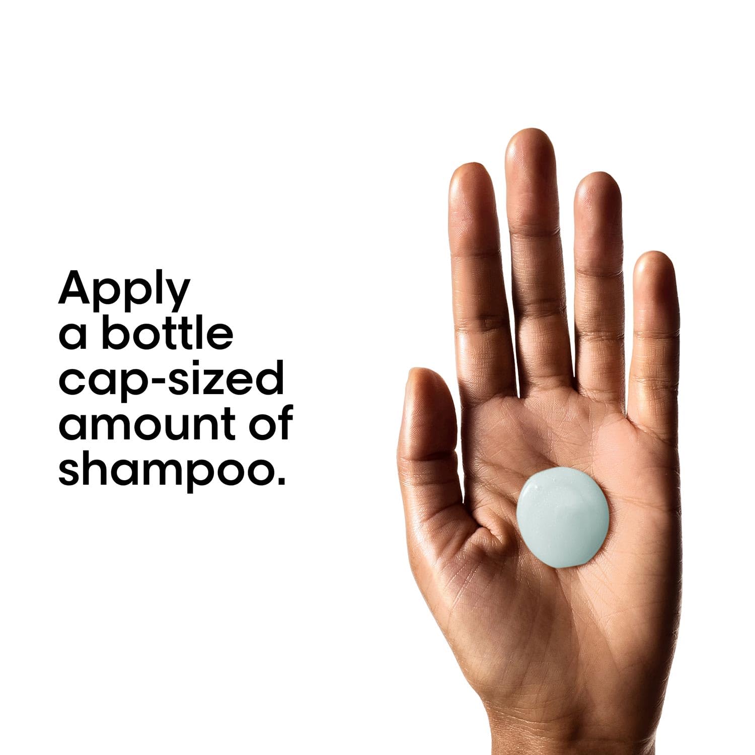 Hand holding a small bottle cap-sized amount of shampoo with text on a white background