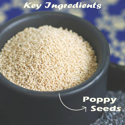 Black bowl filled with poppy seeds on a blue patterned background