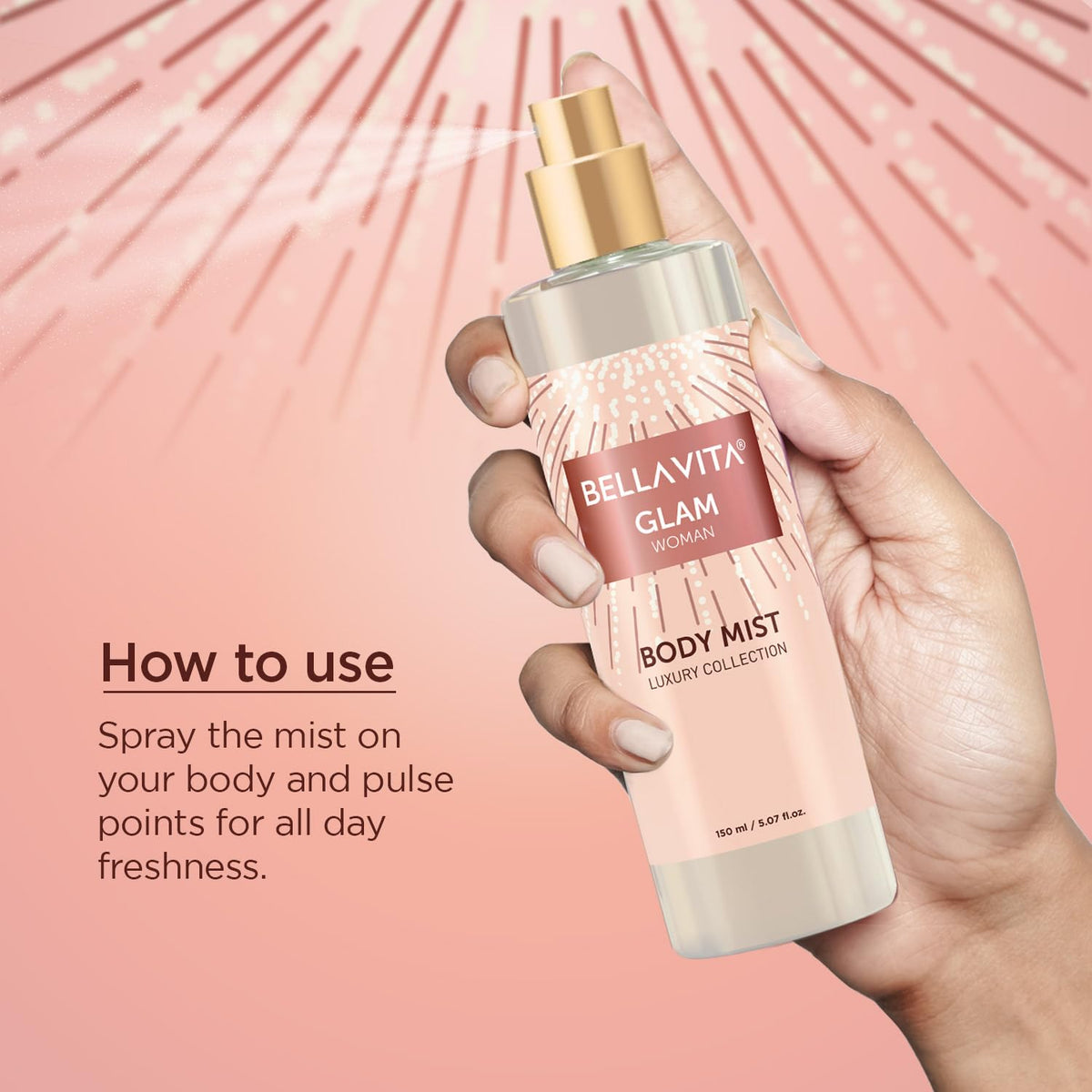 Hand holding a Bellavita Glam body mist bottle with product details on a pink background