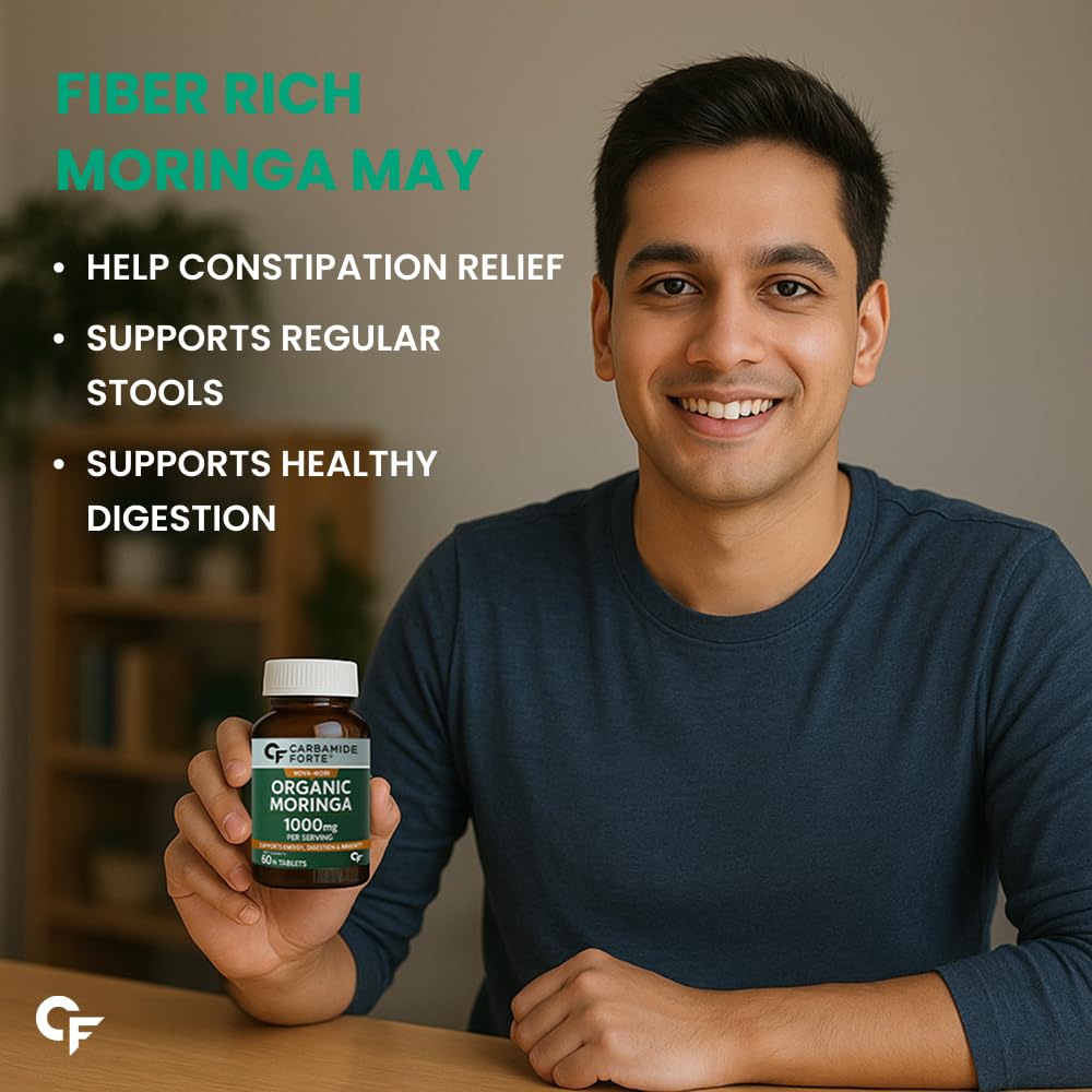 Man holding a bottle of Organic Moringa with text about its benefits on a blurred background