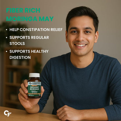 Man holding a bottle of Organic Moringa with text about its benefits on a blurred background