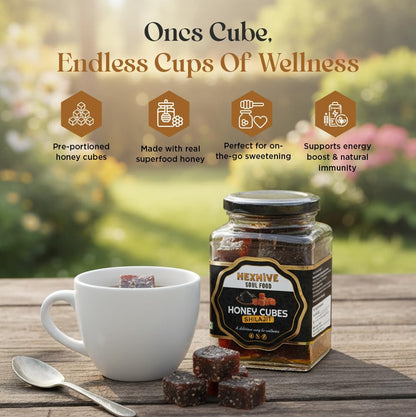 Jar of honey cubes with a cup and spoon on a wooden surface, featuring text about 'Ones Cube' product.