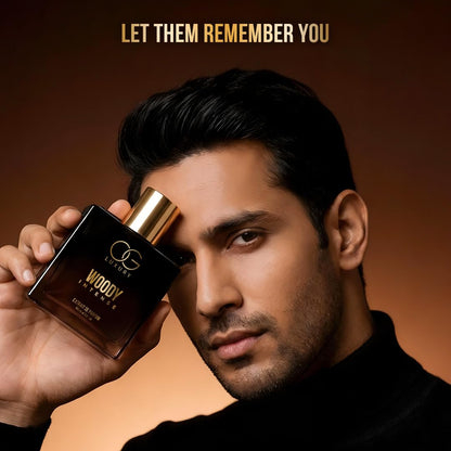 Man holding a perfume bottle with text 'Let Them Remember You' on a brown background