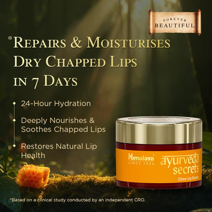 Ayurveda Secrets lip balm jar with natural elements and product benefits text on a blurred green background.