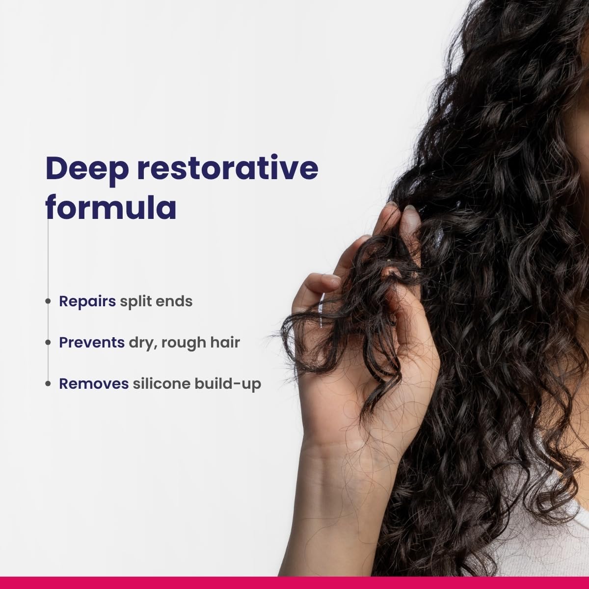Person holding curly hair with text about a deep restorative formula on a white background