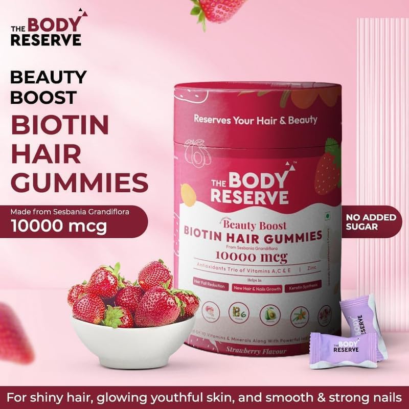 The Body Reserve Beauty Boost Biotin Hair Gummies packaging with strawberries on a pink background