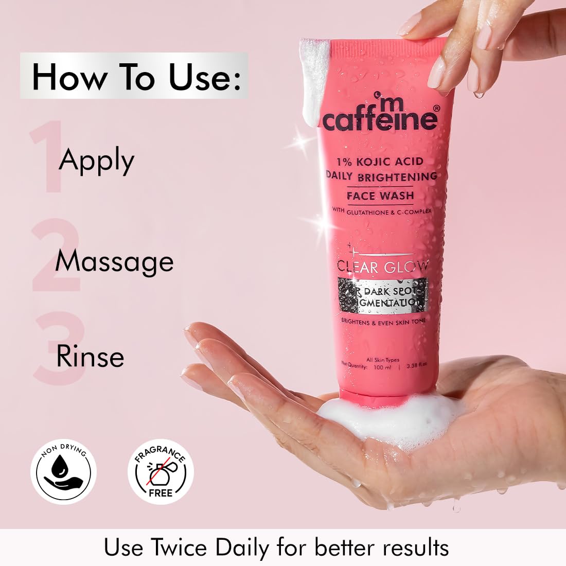 Pink face wash tube with application instructions on a pink background