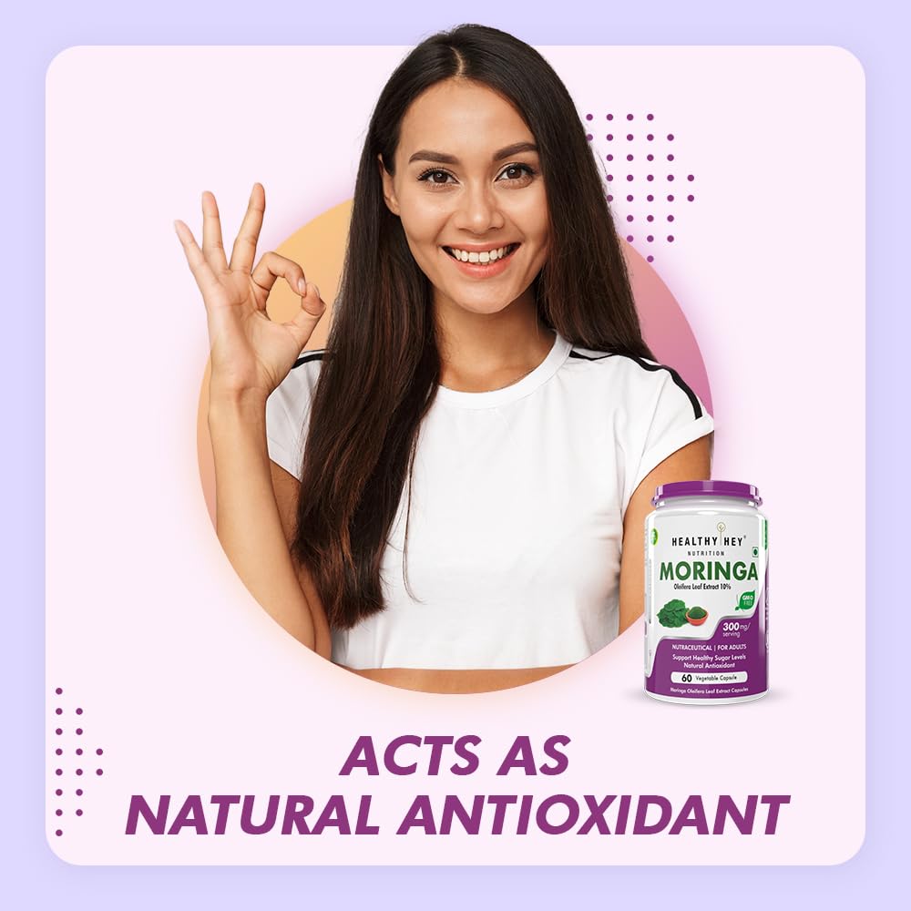 Woman making a peace sign with a Moringa supplement bottle on a light purple background