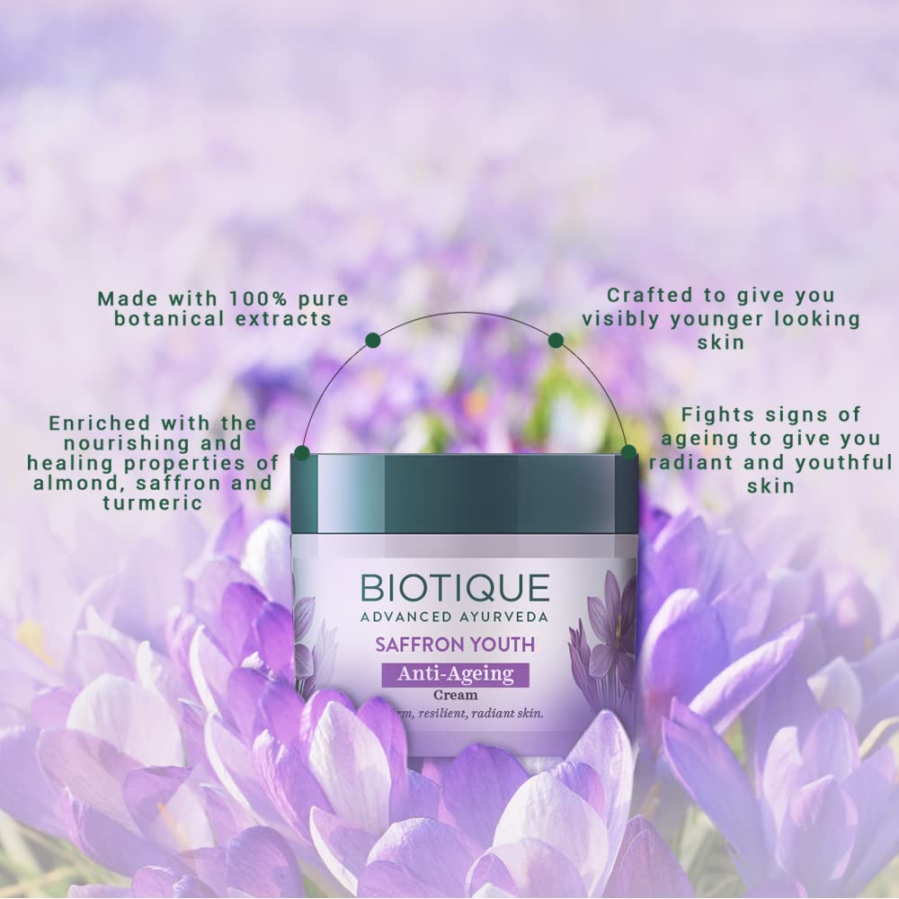 Biotique Saffron Youth Anti-Ageing Cream jar with purple flowers in the background