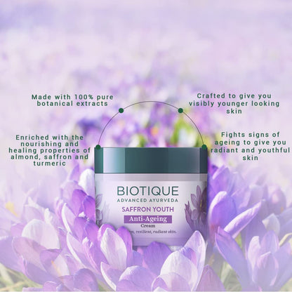 Biotique Saffron Youth Anti-Ageing Cream jar with purple flowers in the background