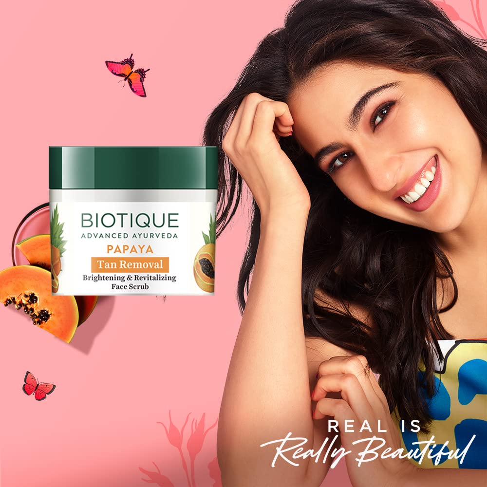 Biotique Papaya face scrub with a woman on a pink background