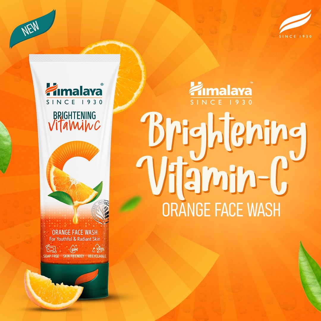 Himalaya Brightening Vitamin C Orange Face Wash packaging on an orange background with oranges and leaves.