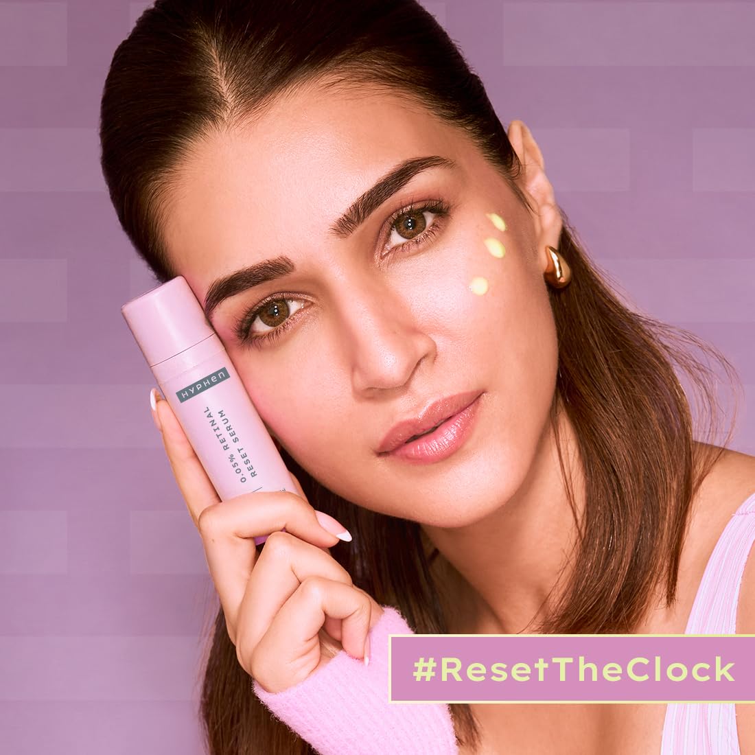 Woman holding a skincare product with a purple background and '#ResetTheClock' text.