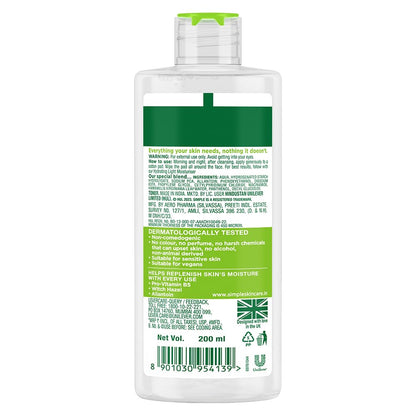 Bottle of Simple Kind To Skin body wash with green label on a white background