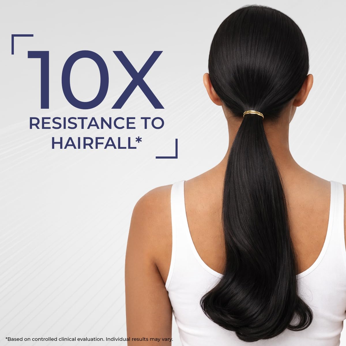 Woman with a ponytail on a white background with text about hairfall resistance.