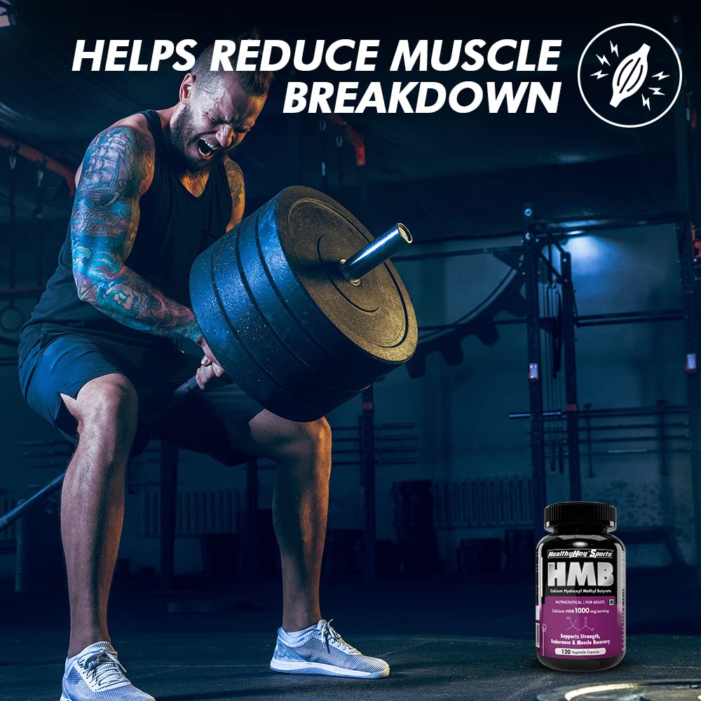 Man lifting weights with a bottle of HMB supplement in a gym setting
