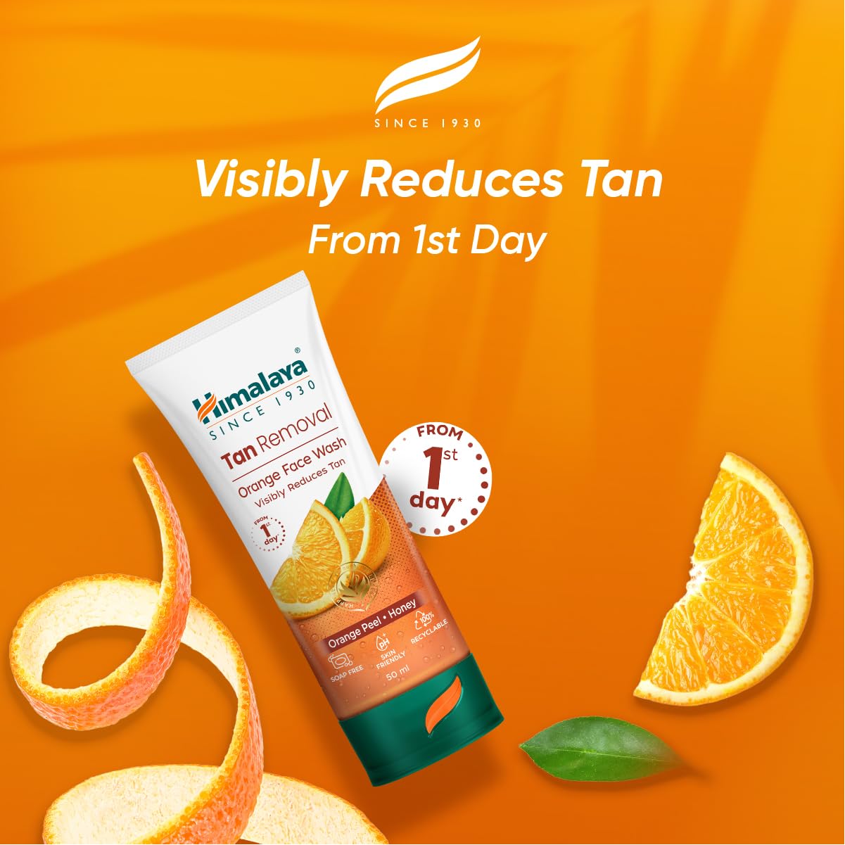 Himalaya Orange Face Wash tube on an orange background with oranges and peels.